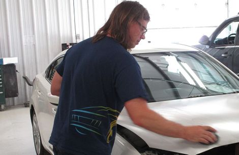 photo of man working on car