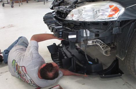 photo of man working on car