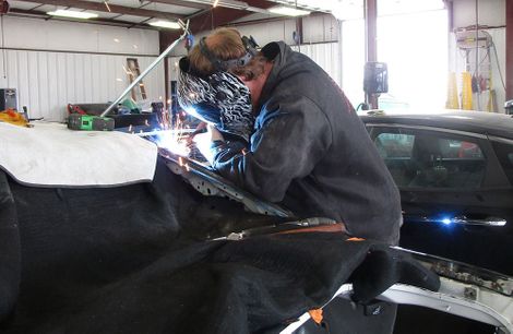 photo of man welding
